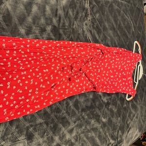 Red midi dress with flowers print and button details on back.